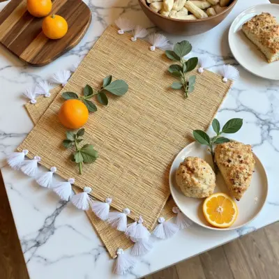4010a607-ae04-4b1e-86a5-d07b8e2a982f.webp Hand-Woven Moroccan Tassel Placemats – Rattan & Cotton Dining Decor (15.5″ × 12″)