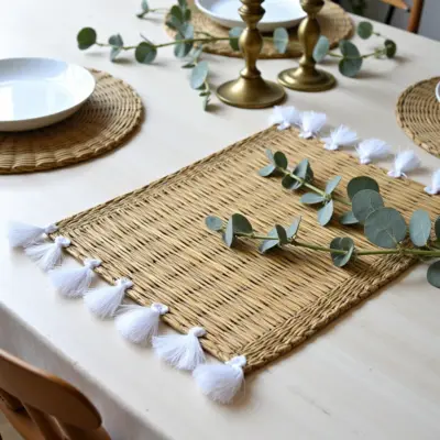 43a98565-1424-4a9f-806f-5626948f6e36.webp Hand-Woven Moroccan Tassel Placemats – Rattan & Cotton Dining Decor (15.5″ × 12″)