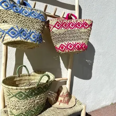 43bdf4286e59513e5104f6963483a4525d3dd8d1678df91716f85896cb70ef4d-1.webp Embroidered Palm Fiber Basket – Handwoven Moroccan Tote with Wool Embroidery