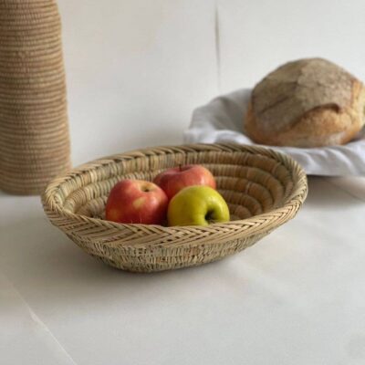 5fd1f9df358c0fd69f82fcb5a5e1bf292fb5b8d59d9d8b8150105cccd415870c-1.jpeg Handwoven Palm Leaf Basket – Fruit, Bread & Decorative Storage