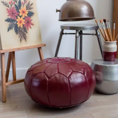 Deep-Red-Leather-Pouf-Round-4.webp Deep Red Moroccan Leather Pouf – Handcrafted Round Ottoman (21″ × 12″)