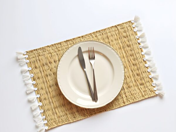 Hand-Woven-Moroccan-Tassel-Placemats.jpg Hand-Woven Moroccan Tassel Placemats – Rattan & Cotton Dining Decor (15.5″ × 12″)