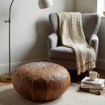 Handmade-Moroccan-Leather-Pouf-Natural-Tan-4.webp Natural Leather Moroccan Pouf – Handcrafted Round Ottoman (21″ × 12″)