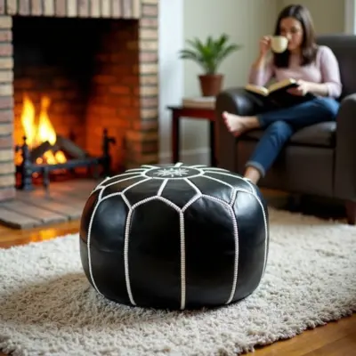 Round-Black-Moroccan-Leather-Pouf-with-White-Stitch-3.webp Black Moroccan Leather Pouf – Handcrafted Round Ottoman with White Stitching (21″ × 12″)