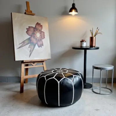 Round-Black-Moroccan-Leather-Pouf-with-White-Stitch-4.webp Black Moroccan Leather Pouf – Handcrafted Round Ottoman with White Stitching (21″ × 12″)