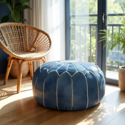 Round-Moroccan-Leather-Pouf-Blue-2.webp Denim Blue Leather Pouf – Handcrafted Moroccan Ottoman with Sunburst Stitching