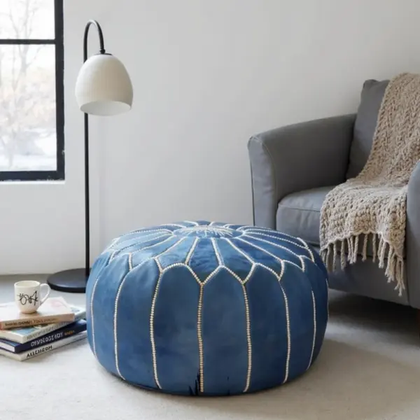 Round-Moroccan-Leather-Pouf-Blue-3-1000x1000-1.webp Denim Blue Leather Pouf – Handcrafted Moroccan Ottoman with Sunburst Stitching
