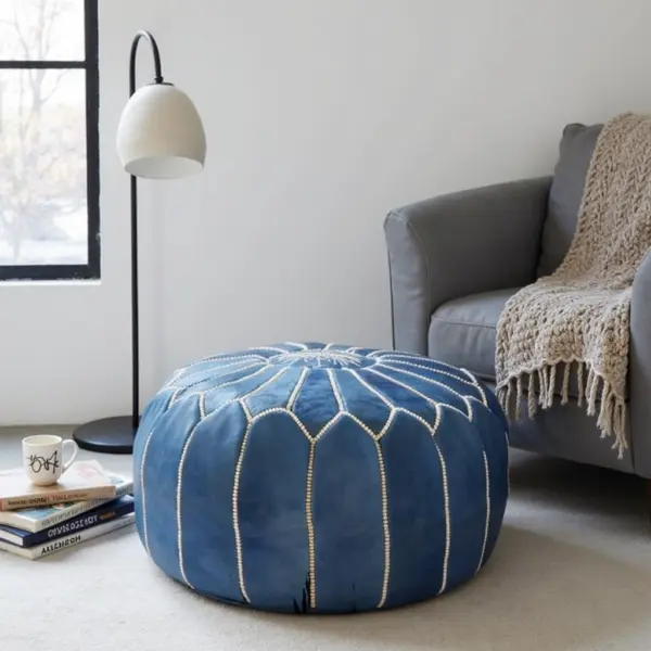 Round-Moroccan-Leather-Pouf-Blue-3.webp Denim Blue Leather Pouf – Handcrafted Moroccan Ottoman with Sunburst Stitching