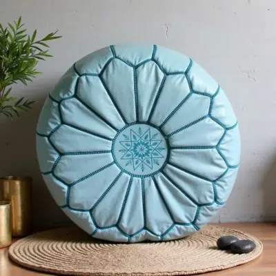 Round-Moroccan-Leather-Pouf-Blue-Sky-3.webp Sky Blue Leather Pouf Ottoman – Handcrafted Moroccan Round Pouf (21″ × 12″)