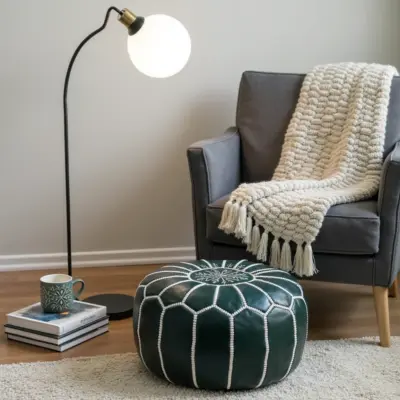 Round-Moroccan-Leather-Pouf-Green-1-1.webp Handcrafted Green Leather Pouf – 21″ Moroccan Round Ottoman with White Stitching
