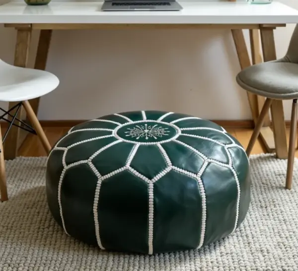 Round-Moroccan-Leather-Pouf-Green-4-e1733396210425-768x698-1.webp Handcrafted Green Leather Pouf – 21″ Moroccan Round Ottoman with White Stitching