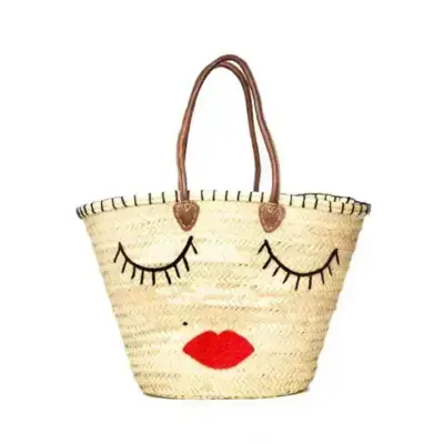 a4258940d5a22b05324c62d1e35f883e42b4e8d1b3b7d240bef134d6447e4376-1.webp Handmade Straw Tote Bag with Eye Pattern – Moroccan Woven Basket with Drawstring Closure
