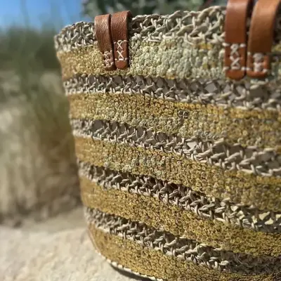 ac2b831ce571b0dc6f498e0cadcb238620decc51163cb272c46a51554ce40be0-1.webp Sequin Basket – Handwoven Doum Palm Fiber Tote with Leather Handles & Drawstring Closure